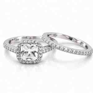 Silver-tone two-ring bridal set with square clear CZ center, halo accents and matching CZ wedding band.