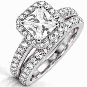 Silver-tone two-ring bridal set with square clear CZ center, halo accents and matching CZ wedding band.