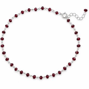 Sterling silver anklet with small deep red garnet beads spaced around the chain and an adjustable extender.