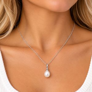 White teardrop freshwater pearl pendant on a fine silver-tone chain with a simple polished bail.