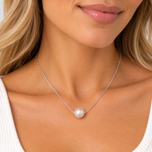 Single white cultured freshwater pearl centered on a delicate sterling silver chain.