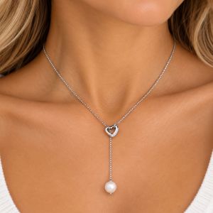 Sterling silver Y necklace with a CZ outline heart connector and single white freshwater pearl drop.