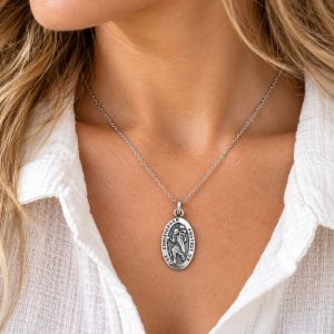 Oxidized sterling silver oval Saint Christopher charm with raised figure and Christopher Protect Us lettering.