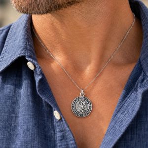 Round oxidized sterling silver Saint Christopher medal with raised figure and “Saint Christopher Protect Us” lettering.